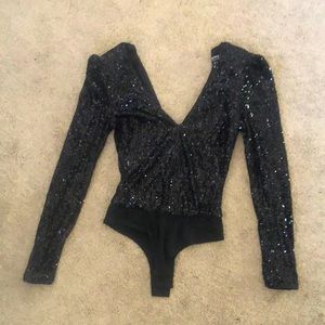 Sparkly black long sleeve body suit.